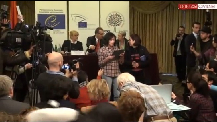 Lena Nazaryan reads her statement during the press conference. | Via Armenianweekly.com