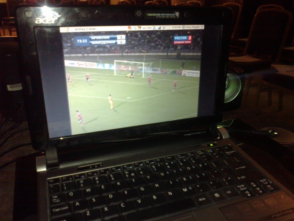 Football match Armenia - Macedonia on a laptop screen next to a projector