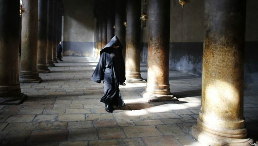 Palestine -- An Armenian Orthodox priest walks inside the Church of the Nativity after a Christmas procession in the West Bank town of Bethlehem, 18Jan2013